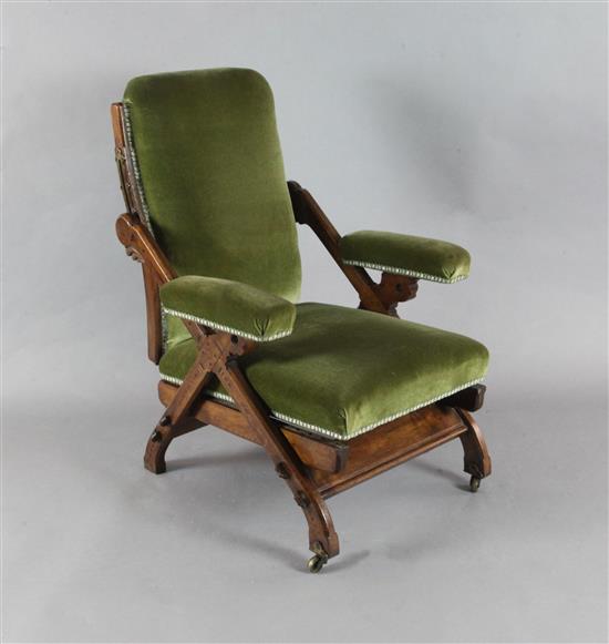 A Victorian Reformed Gothic walnut and marquetry Reclining Chair, designed by Charles Bevan, c.1865, under licence to Marsh, Jones &